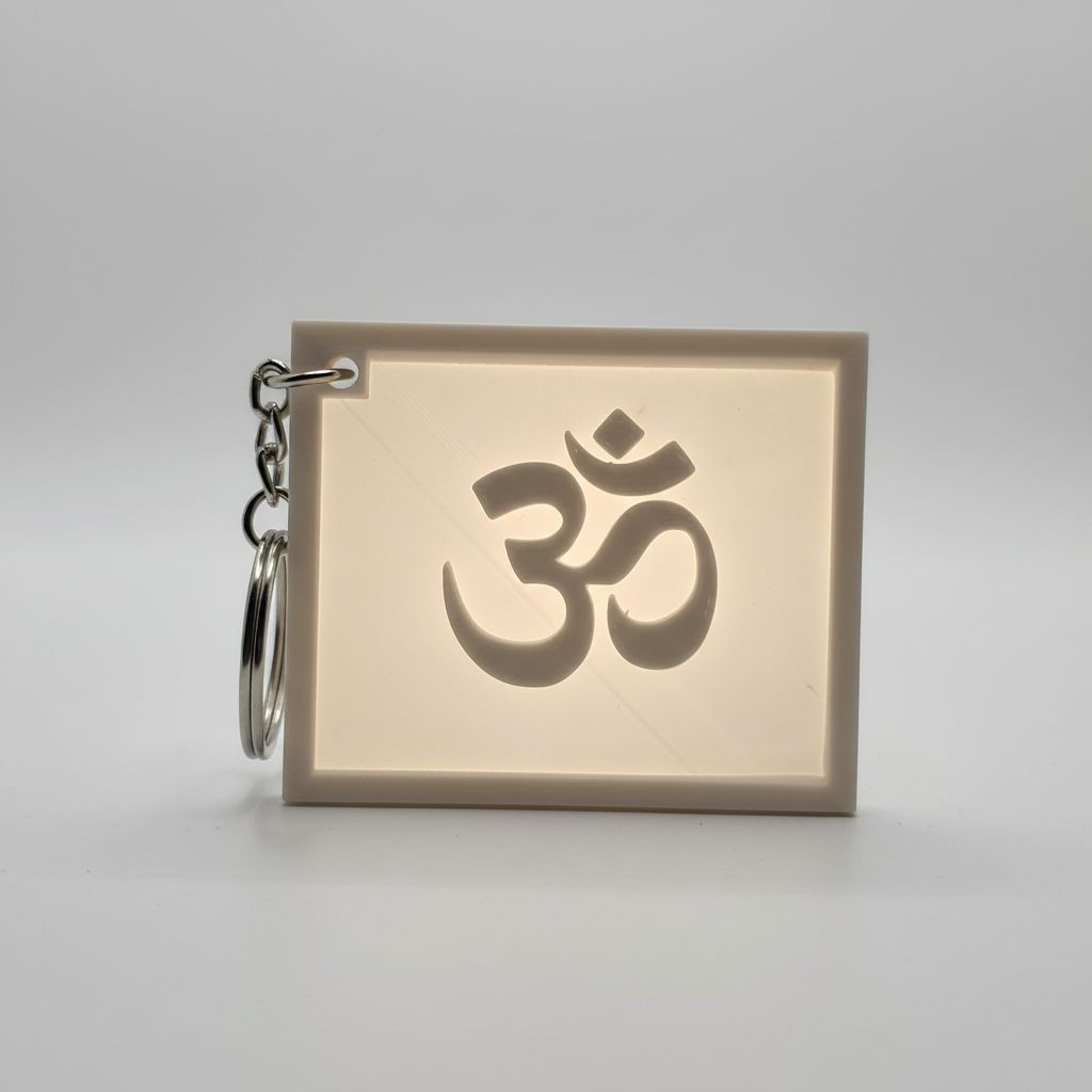 Close-up of Om symbol lithophane keychain showing detailed spiritual design