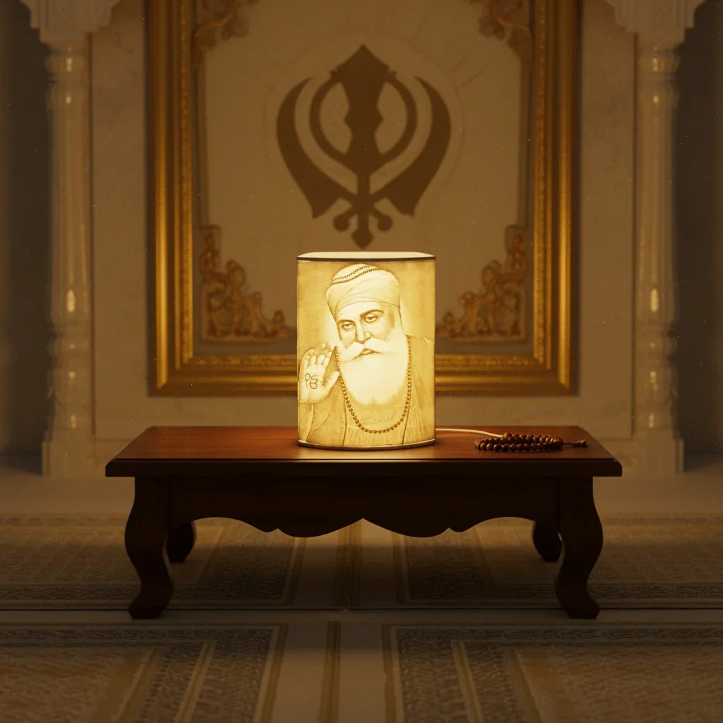 Portrait lamp of Sikh guru on wooden table, prayer beads, Khanda symbol background at The Sculpt Studio