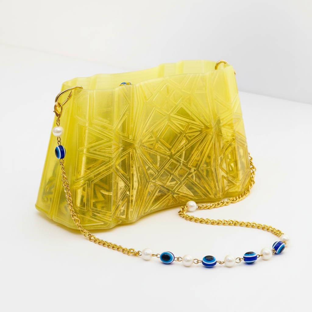 Close-up golden glow purse 3D printed details shimmering texture