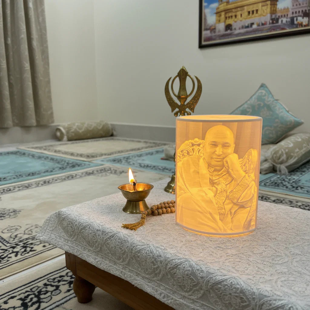 Decorative candle holder with portrait, diya lamp, and beads on table in meditation room, The Sculpt Studio